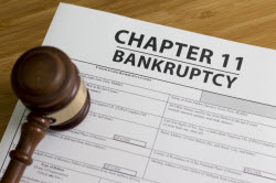 photo of a gavel on a paper that says chapter 11 bankruptcy
